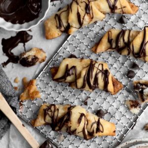 Four gluten free Puff Pastries with Chocolate drizzled in chocolate.