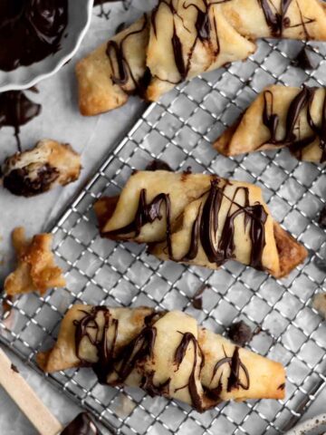 Four gluten free Puff Pastries with Chocolate drizzled in chocolate.