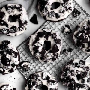 Gluten free Cookies and Cream Donuts sit with crumbled sandwich cookies.