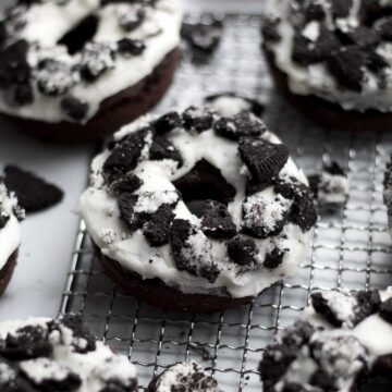 Gluten free Cookies and Cream Donuts sit with crumbled sandwich cookies.