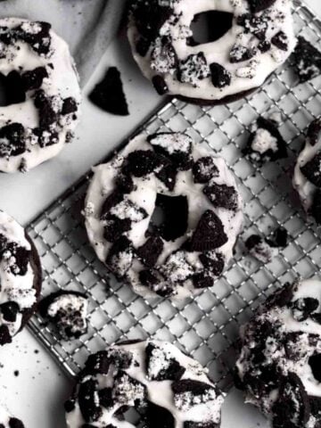 Gluten free Cookies and Cream Donuts sit with crumbled sandwich cookies.
