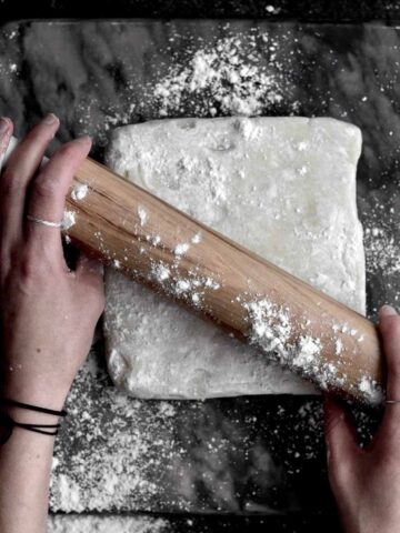 Using a rolling pin on gluten free Puff Pastry Dough.