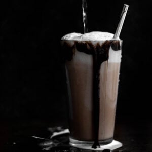 Pouring Seltzer into an overflowing New York Chocolate Egg Cream.
