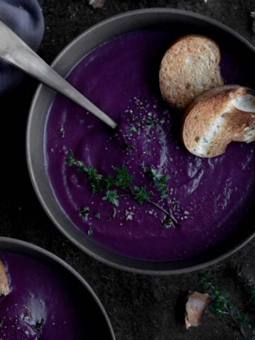 A black bowl of gluten free Purple Sweet Potato Soup.