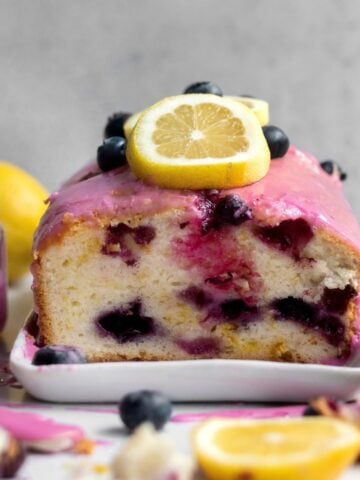 Blueberry Lemon Loaf cut in half showing the blueberry stained insides.