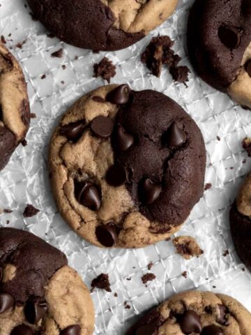 Brookie Cookies sit two-faced on parchment paper, ready to be enjoyed.