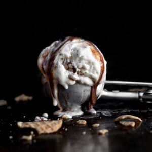 An ice cream scoop with melty Cinnamon Swirl Ice Cream.