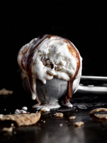 An ice cream scoop with melty Cinnamon Swirl Ice Cream.