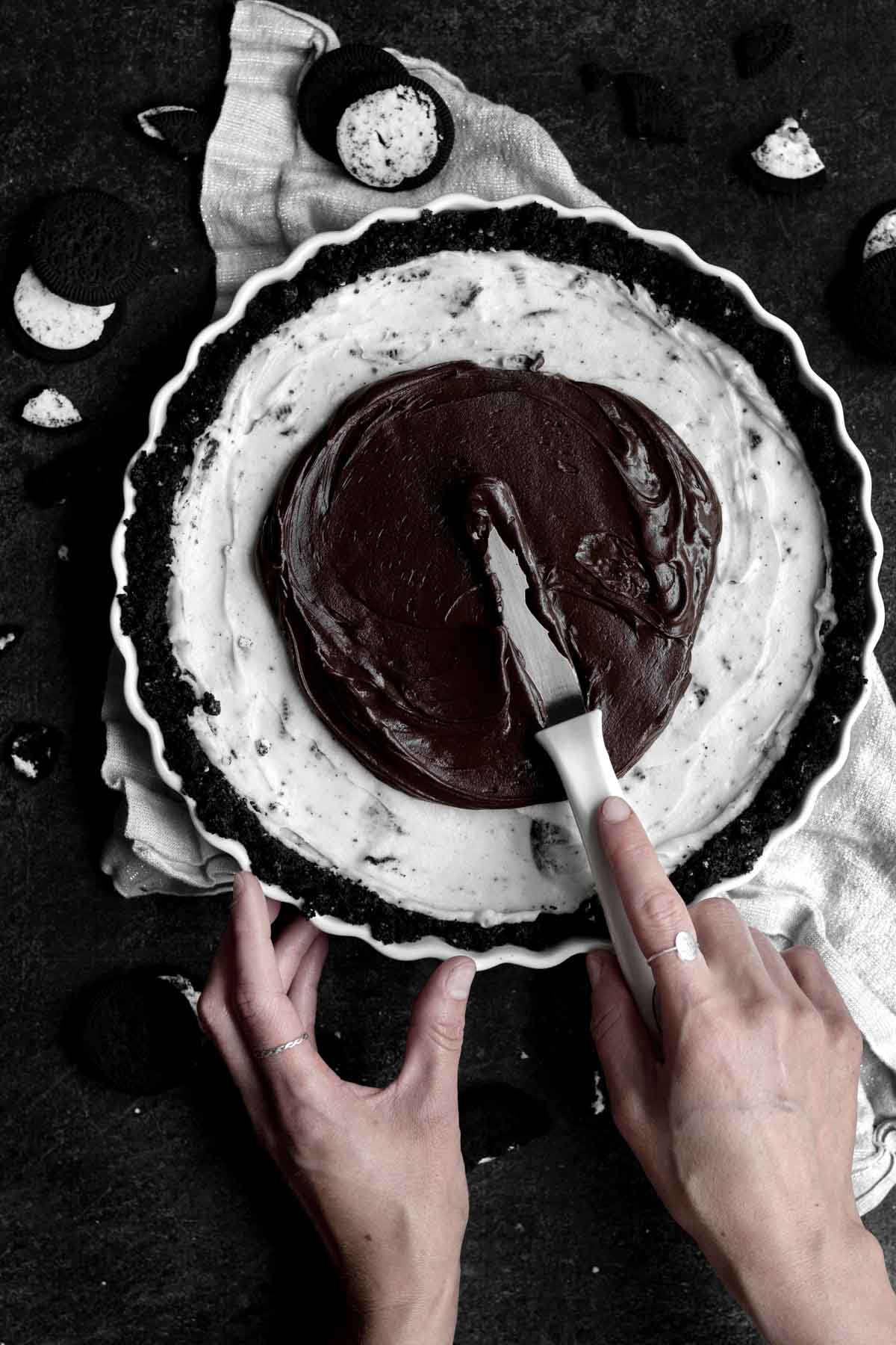 Adding the melted chocolate top to the tart.