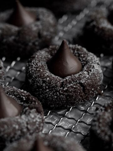 Chocolate Blossom Cookies with white sparkling crystalized sugar flecks and a smooth milk chocolate kiss.
