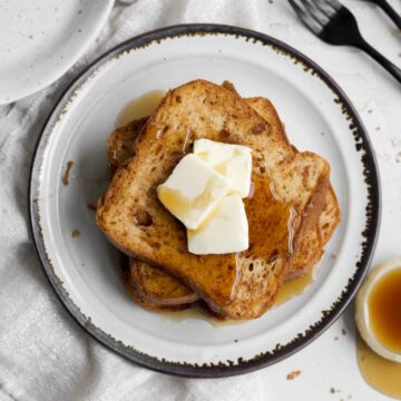 butter and syrup descend from the top of a stack of easy no egg french toast.