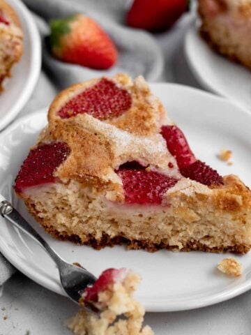 A slice of delicious Eggless Strawberry Cake on a plate.