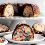 Baked rainbow sprinkles stain the insides of this bundt cake slice.