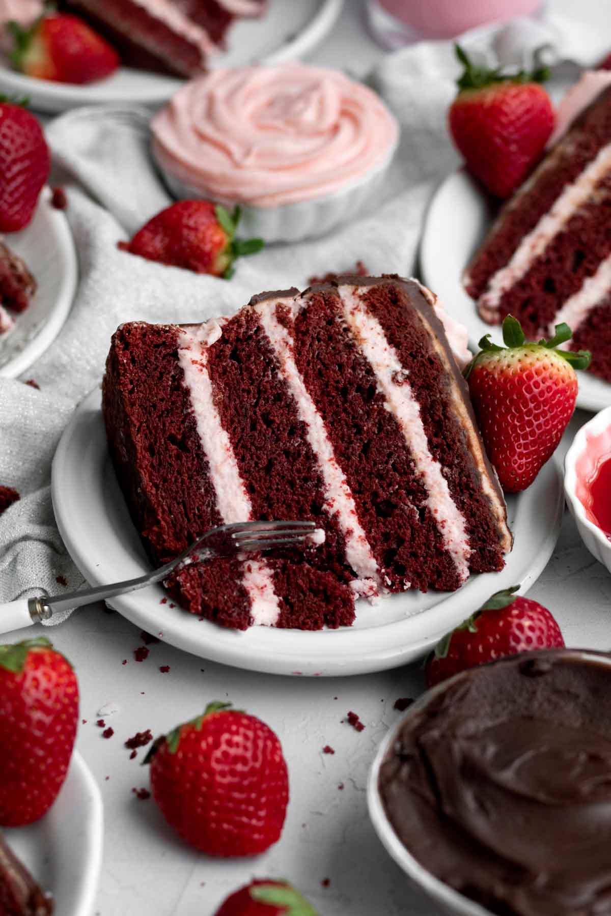 A slice of Strawberry Red Velvet Cake's alternating layers.