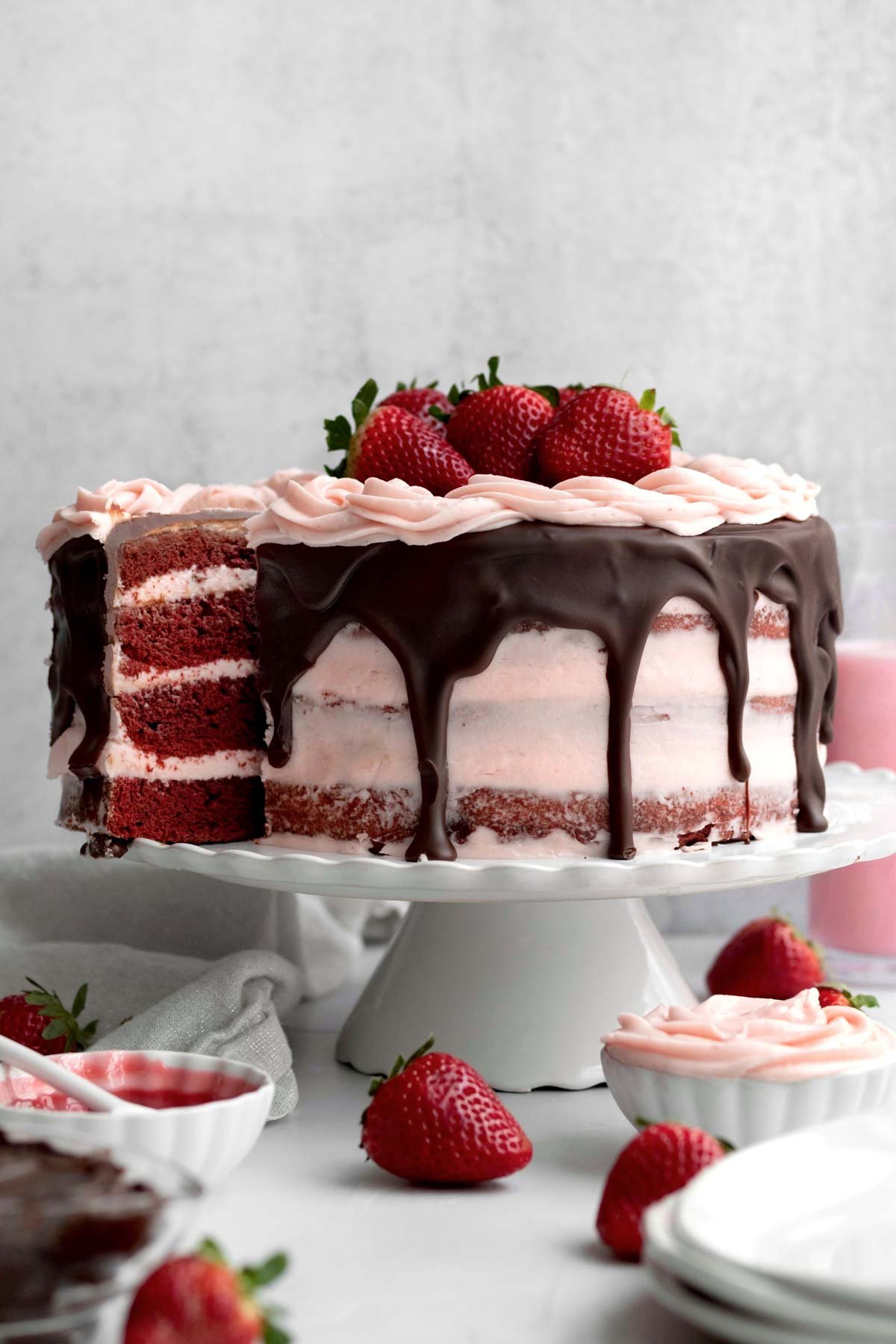 A slice of Strawberry Red Velvet Cake pulled from the whole.
