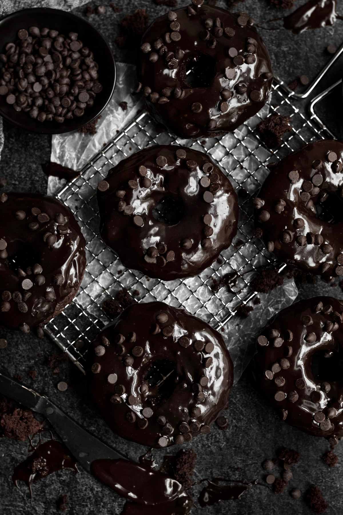 Baked Chocolate Donuts on a baking rack.