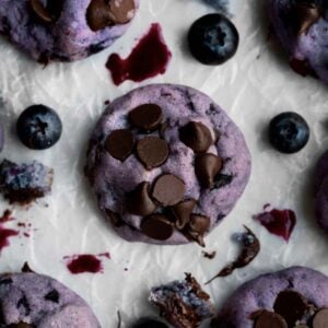 Lavender Blueberry Chocolate Chip Cookie with brown chocolate chips on parchment paper.