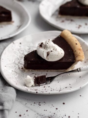 Vegan Chocolate Pudding Pie with a dollop of whipped cream.