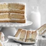 Gluten Free Vanilla Cake with alternating layers of cake and vanilla frosting.