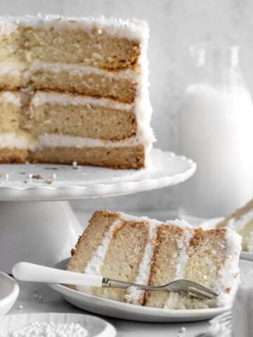 Gluten Free Vanilla Cake with alternating layers of cake and vanilla frosting.