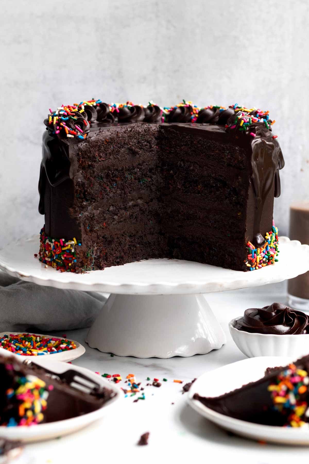 Gluten free Chocolate Sprinkle Cake with slices missing.