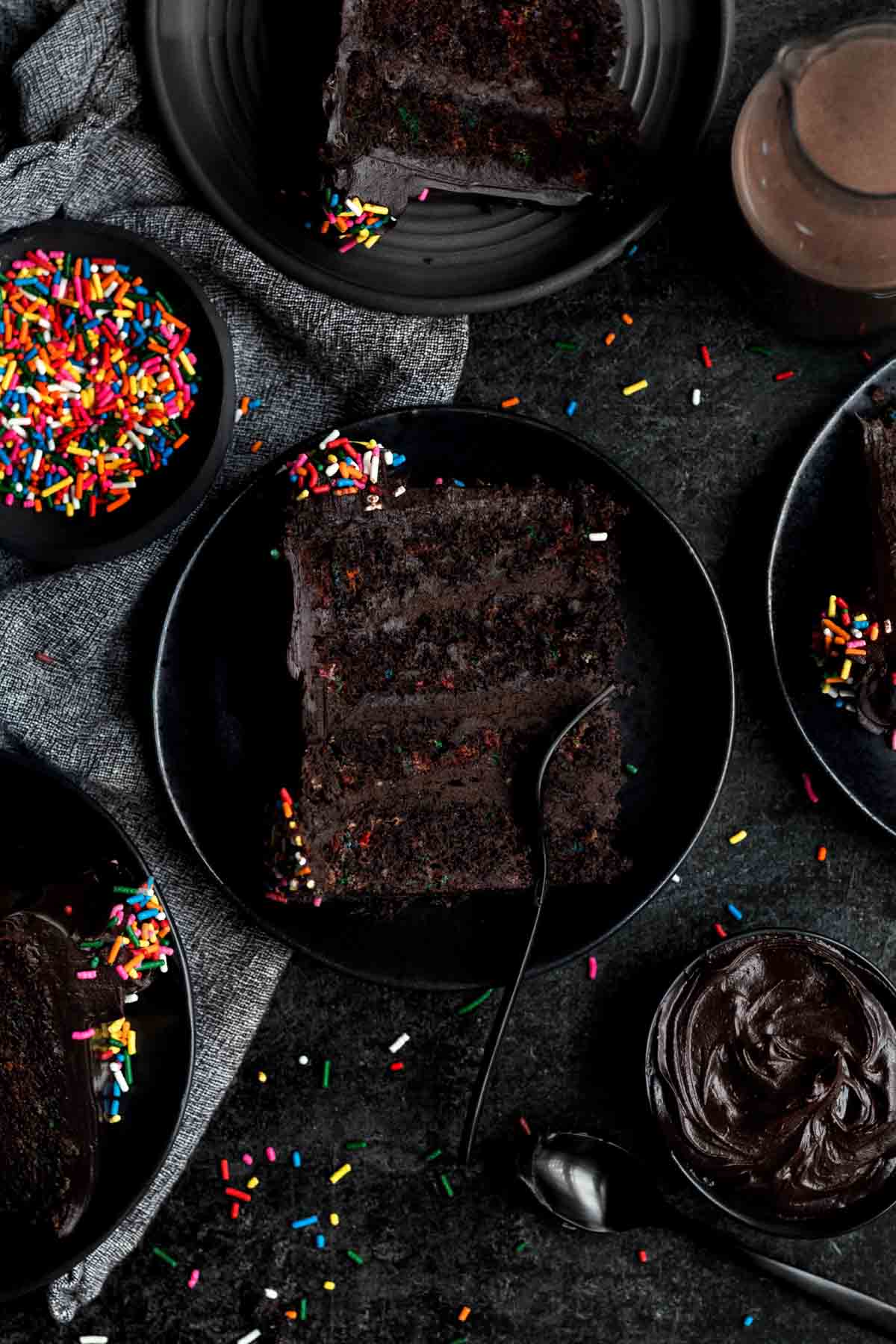 Taking a fork to a slice of cake with a dark background.