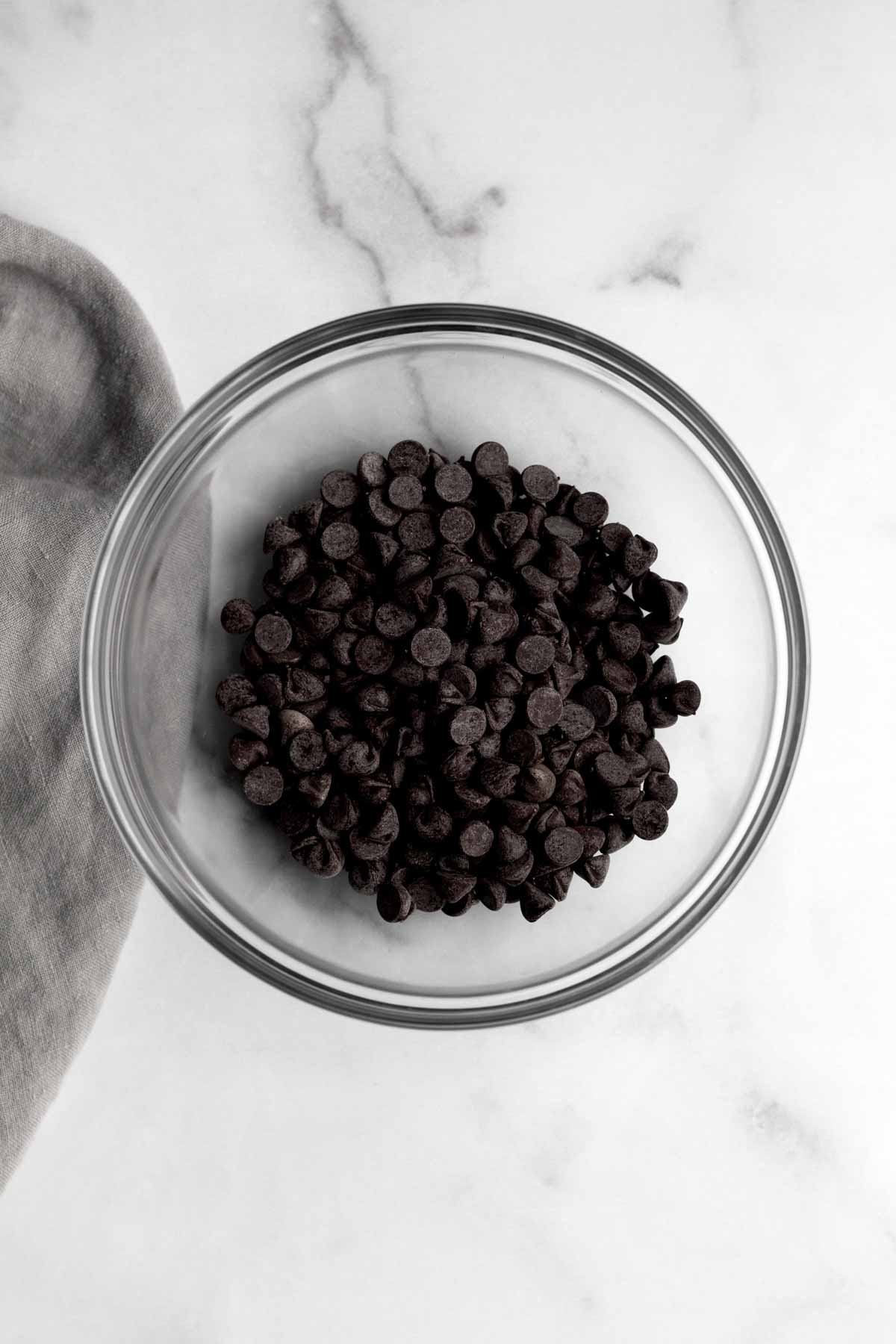 A glass bowl of chocolate chips.