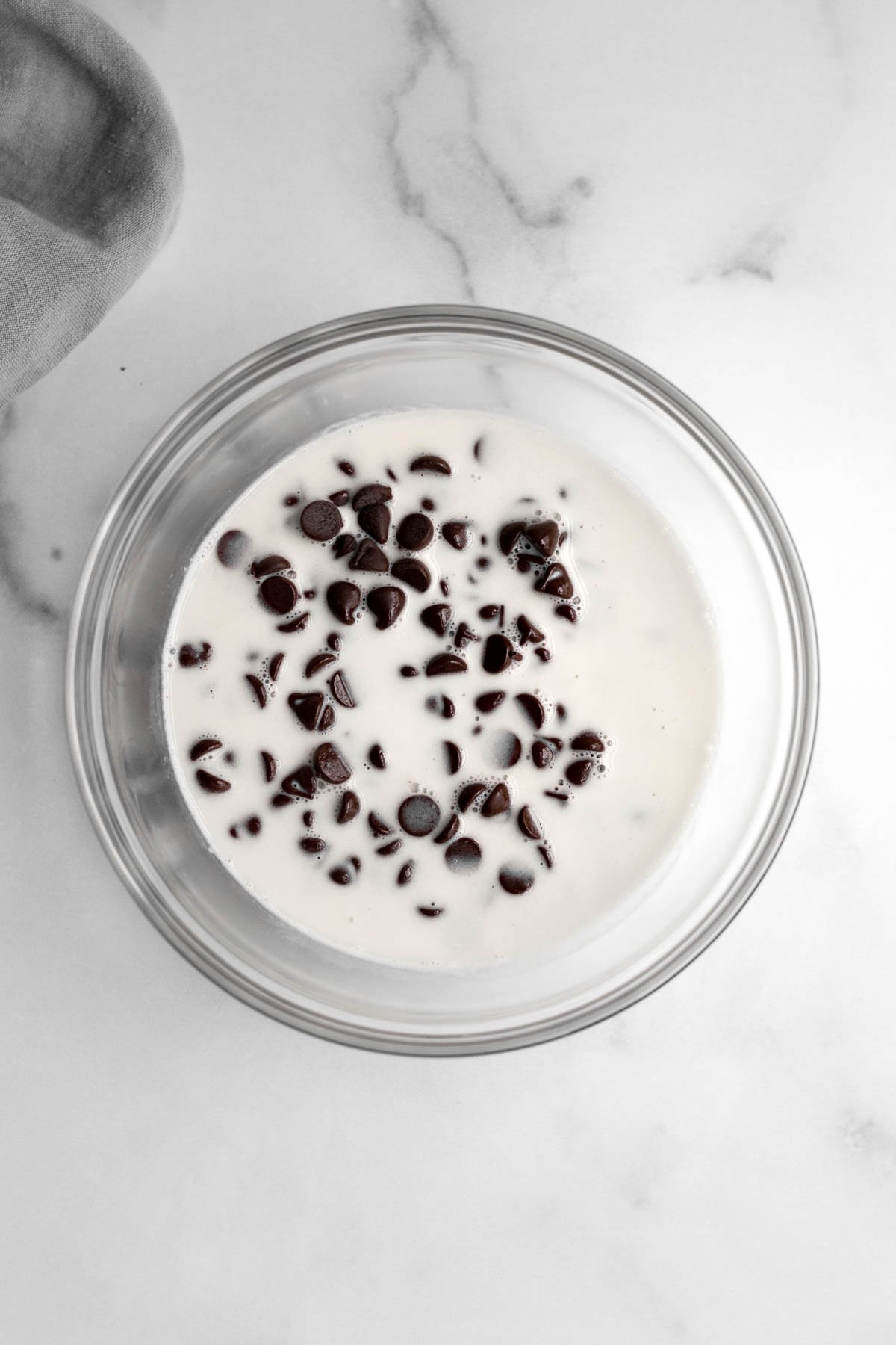 Hot heavy cream is added to the chocolate chips.