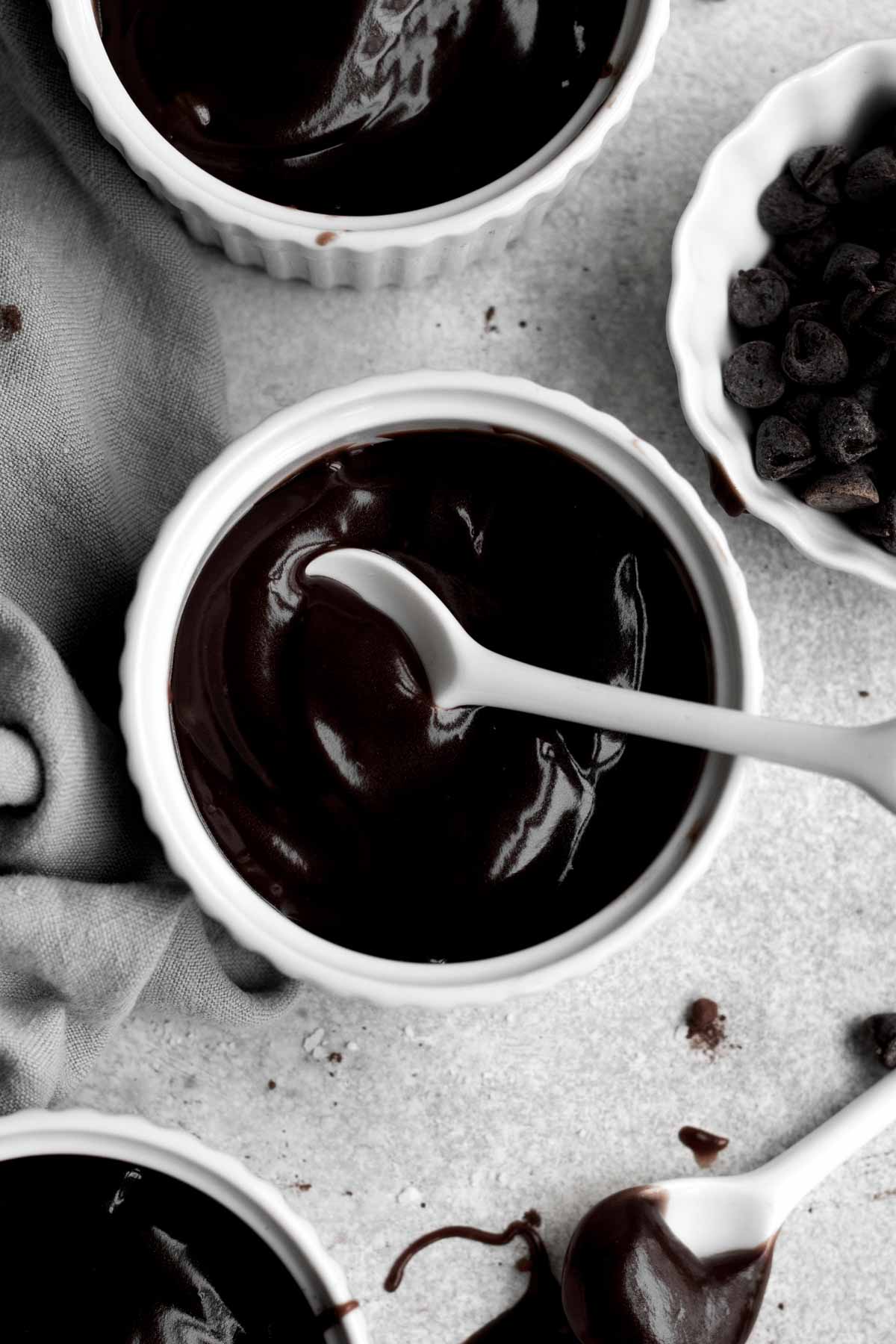 A spoon scoops chocolate pudding.