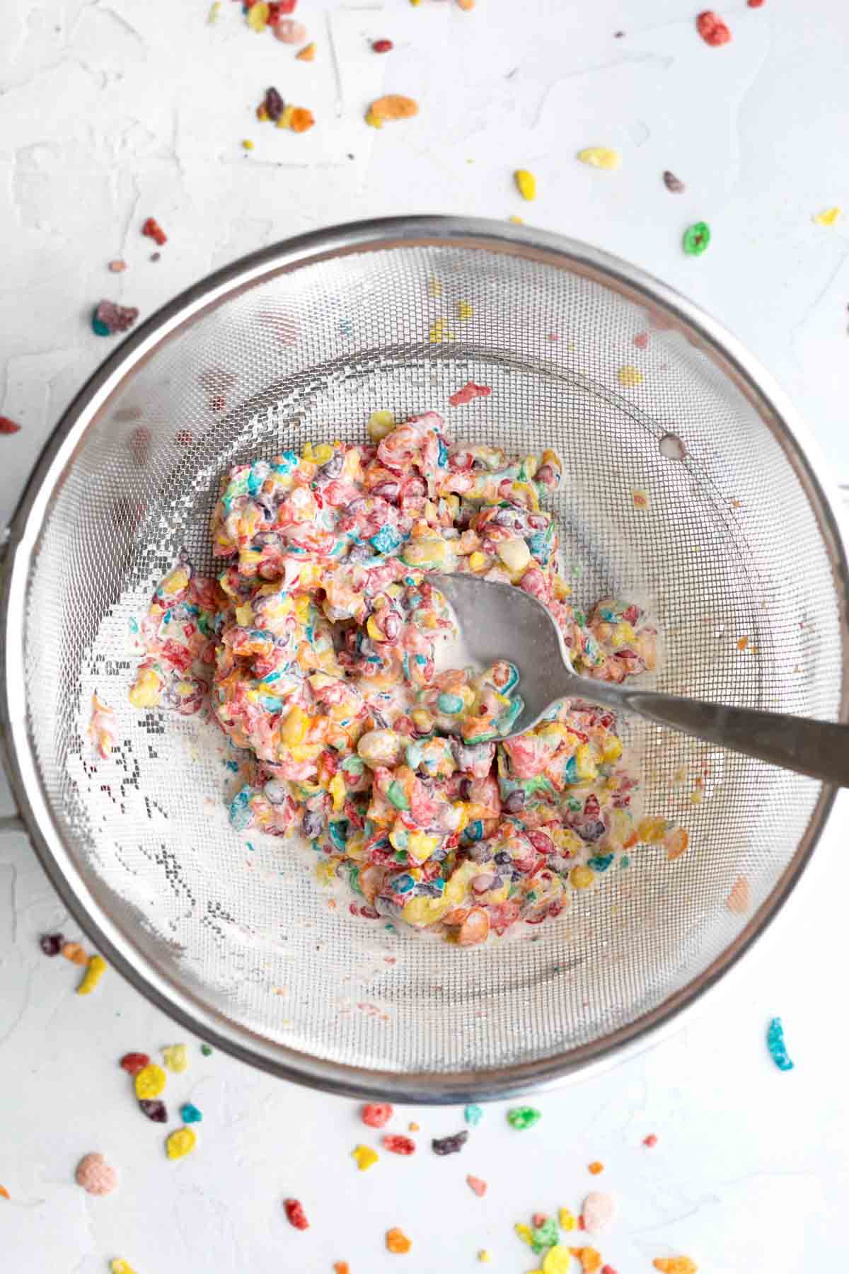 Straining the Fruity Pebbles from the milk.