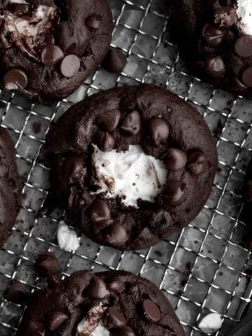 Looking down at a chocolate cookie with a gooey marshmallow center.