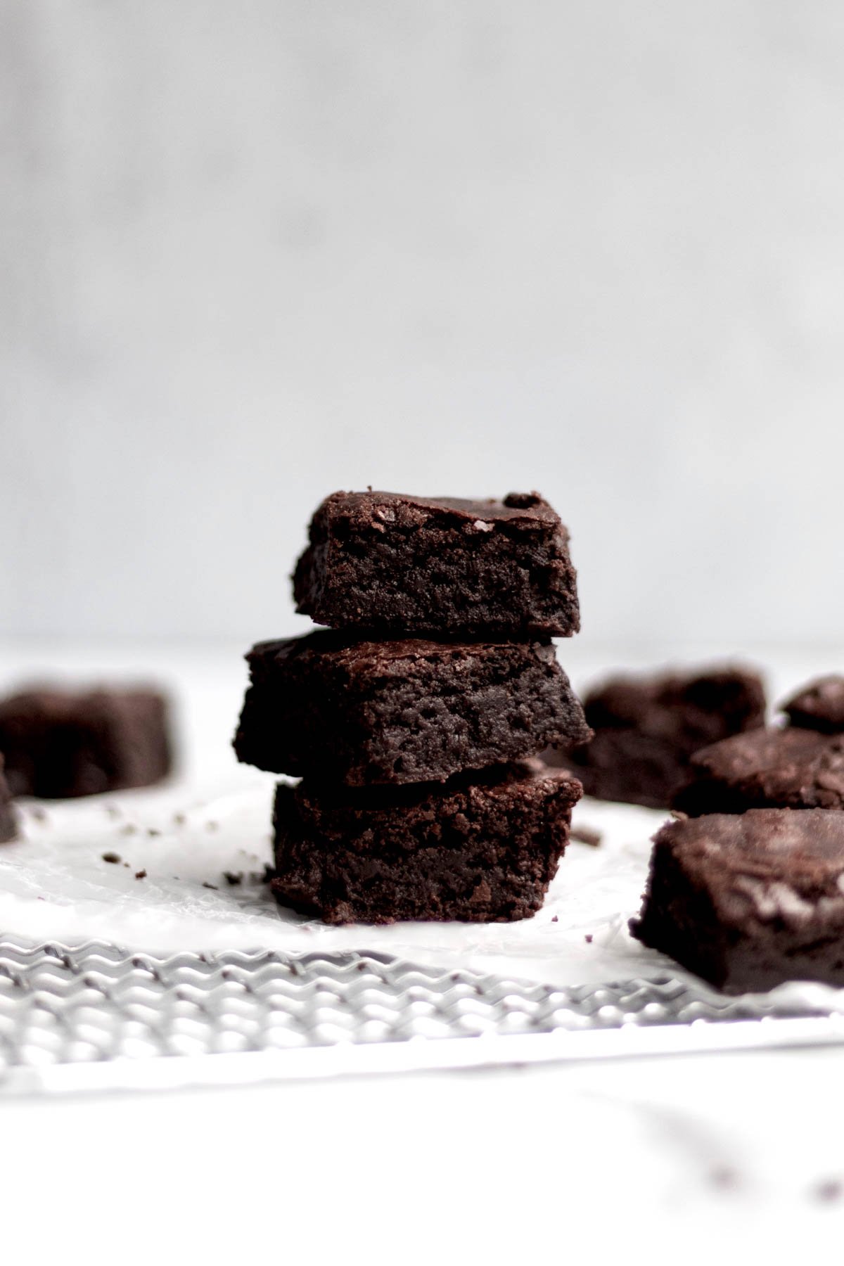 A stack of three Eggless Brownies showing their chewy insides.