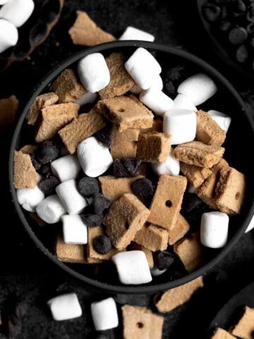 A bowl with chopped gluten free graham crackers, marshmallows and chocolate chips.