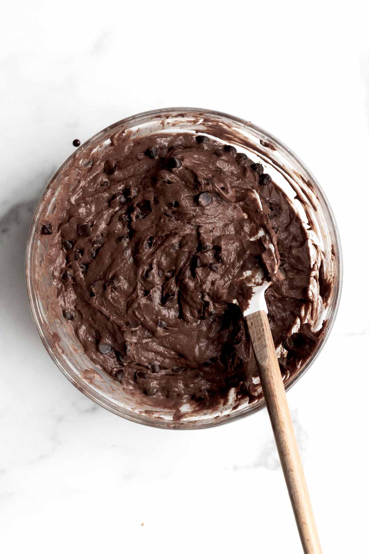 A bowl with thoroughly mixed chocolate chips and batter.