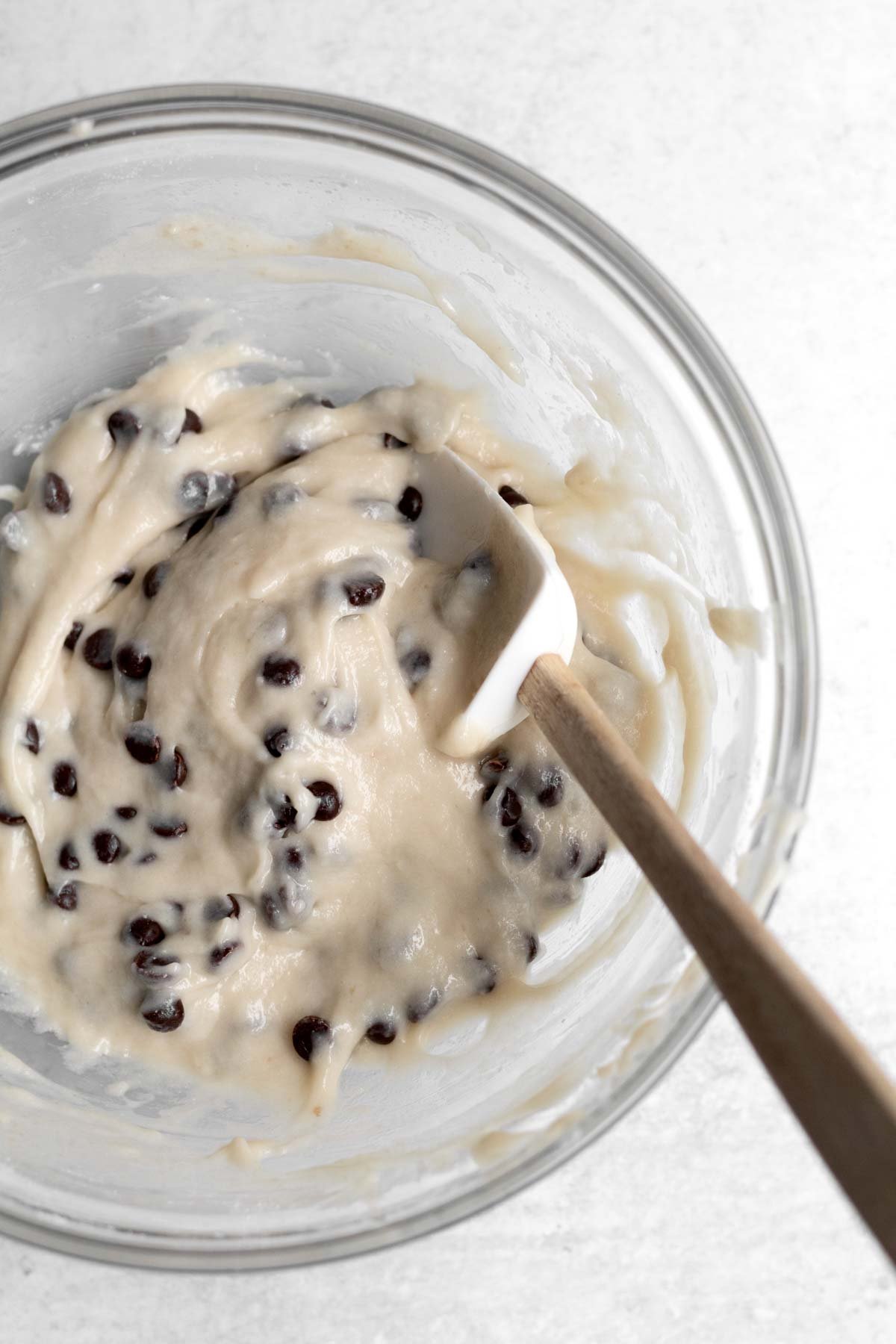 Mixing the chocolate chips throughout with a spatula.