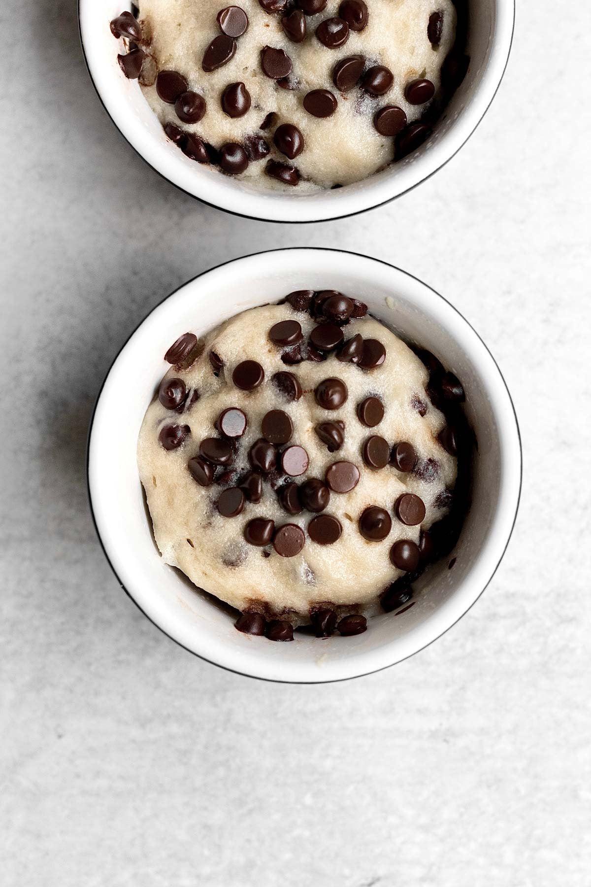 Baked mug cakes with vanilla cake and melty chocolate chips.