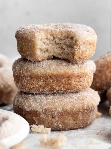 A stack of three delicious gluten free Cinnamon Sugar Donuts.