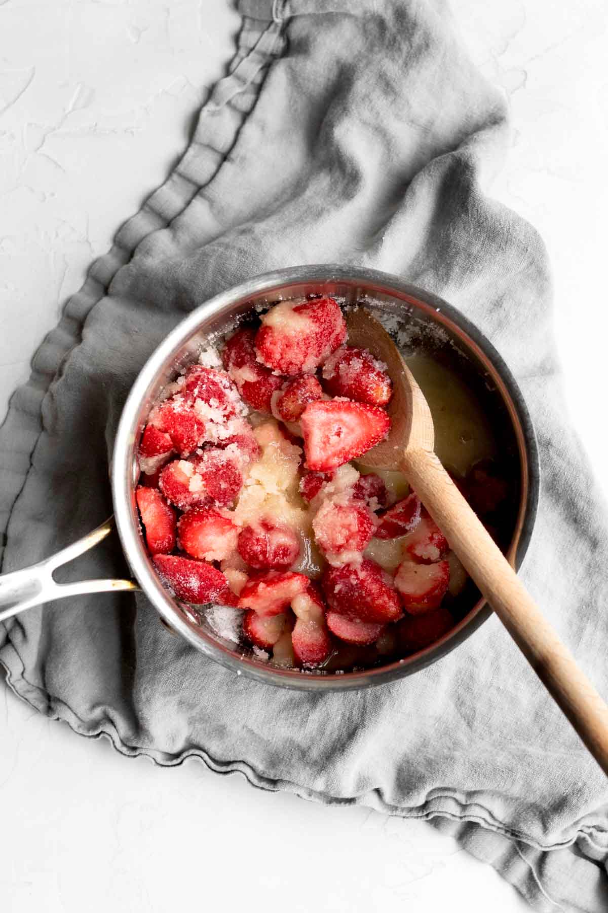 Strawberries, salt, orange juice and sugar in a pan.