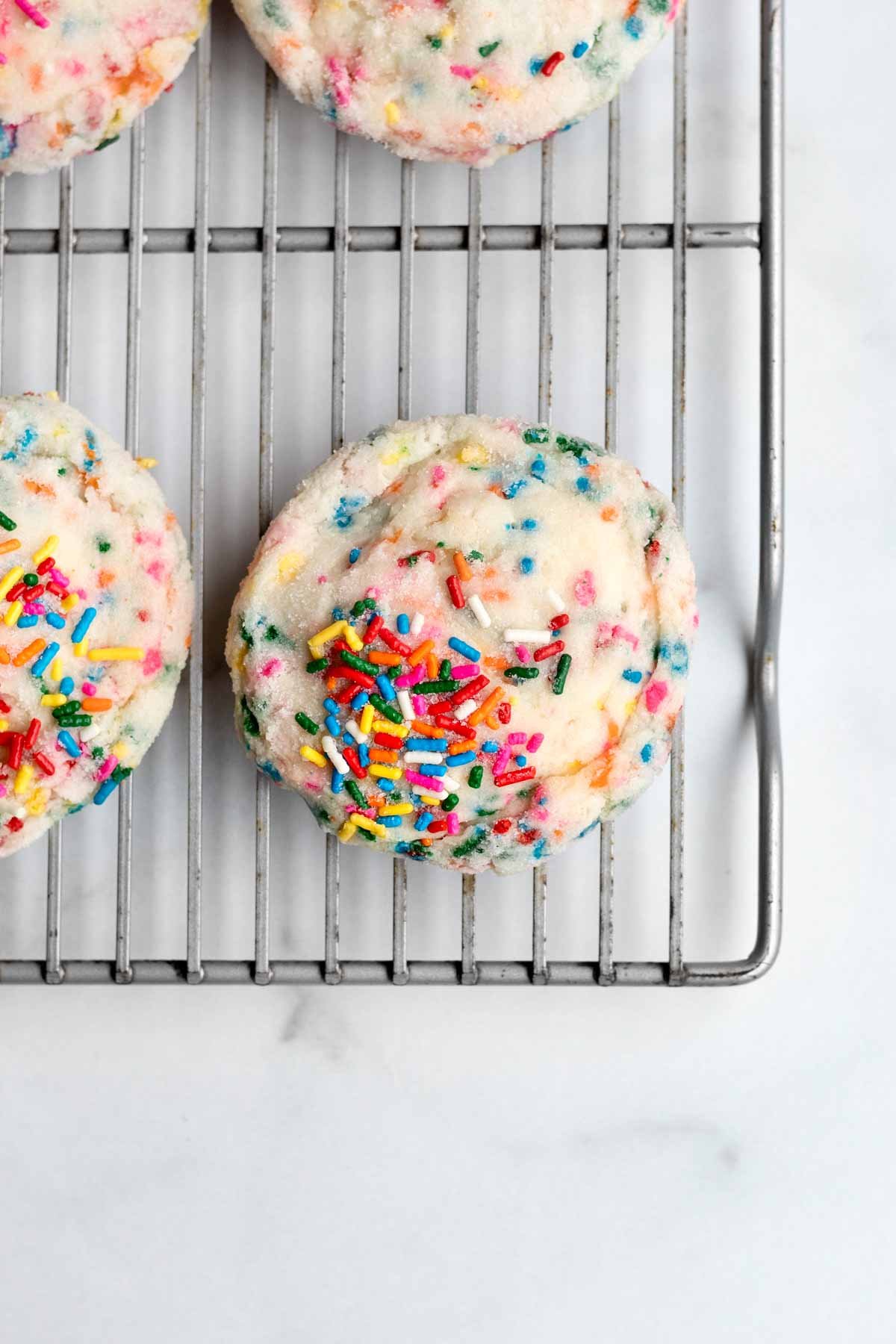 Sprinkle Sugar Cookies on a baking rack.