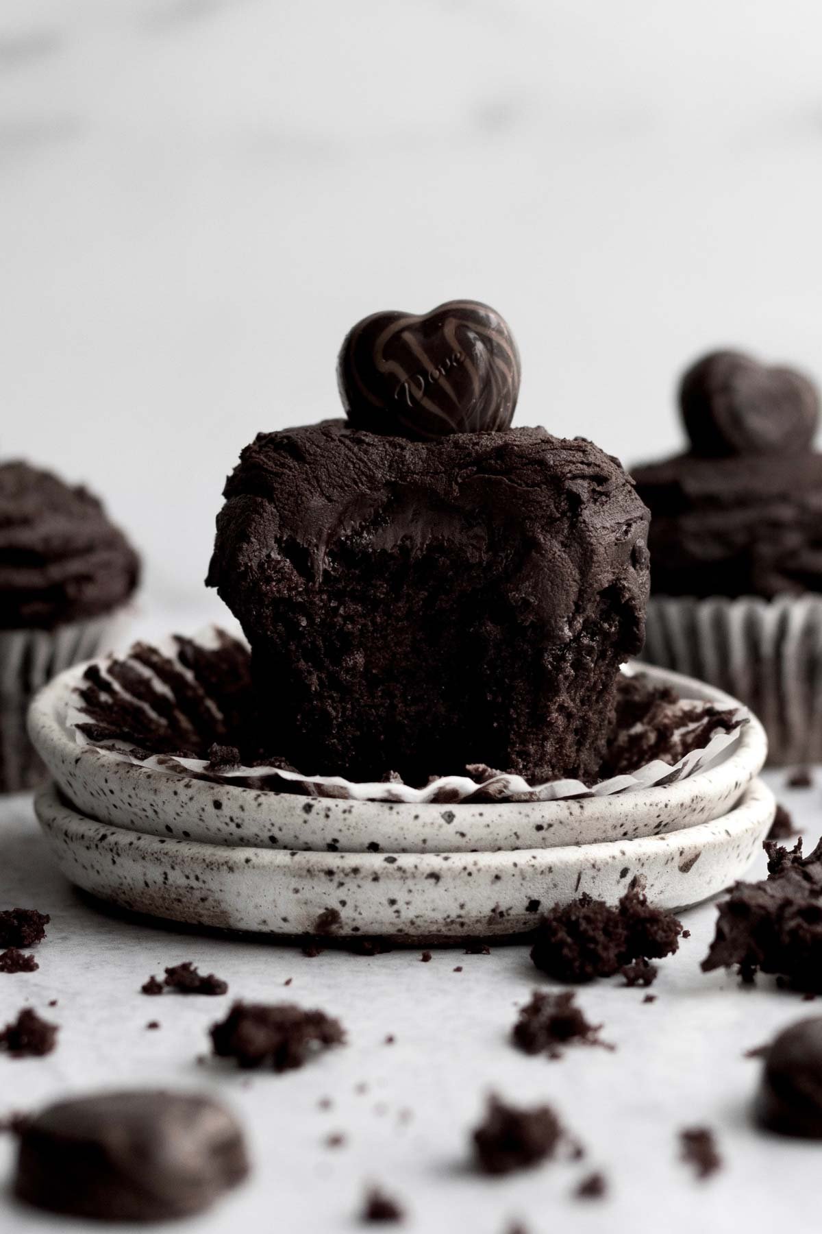 An Eggless Chocolate Cupcake with a bite taken out.