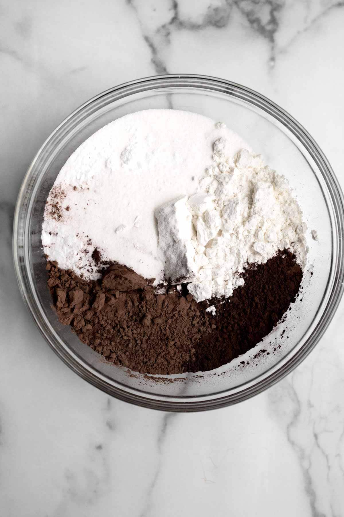 Flour, sugar, cocoa powders, baking soda and salt in a bowl.