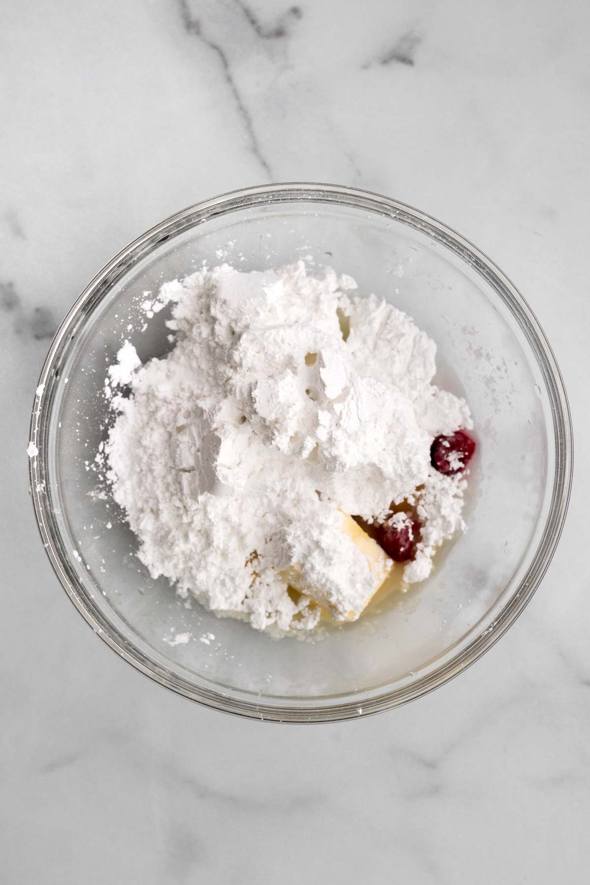 Sugar, water and confectioners' sugar in a bowl.