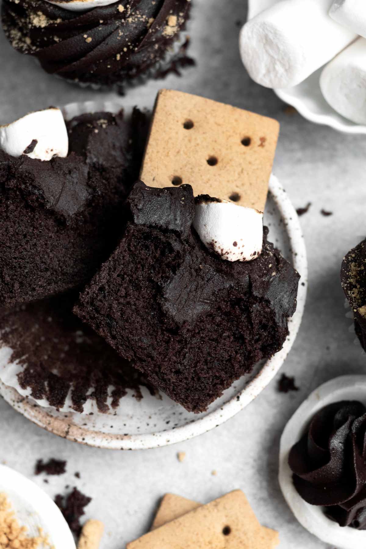 A halved Marshmallow Cupcake displaying the chocolate frosted insides.