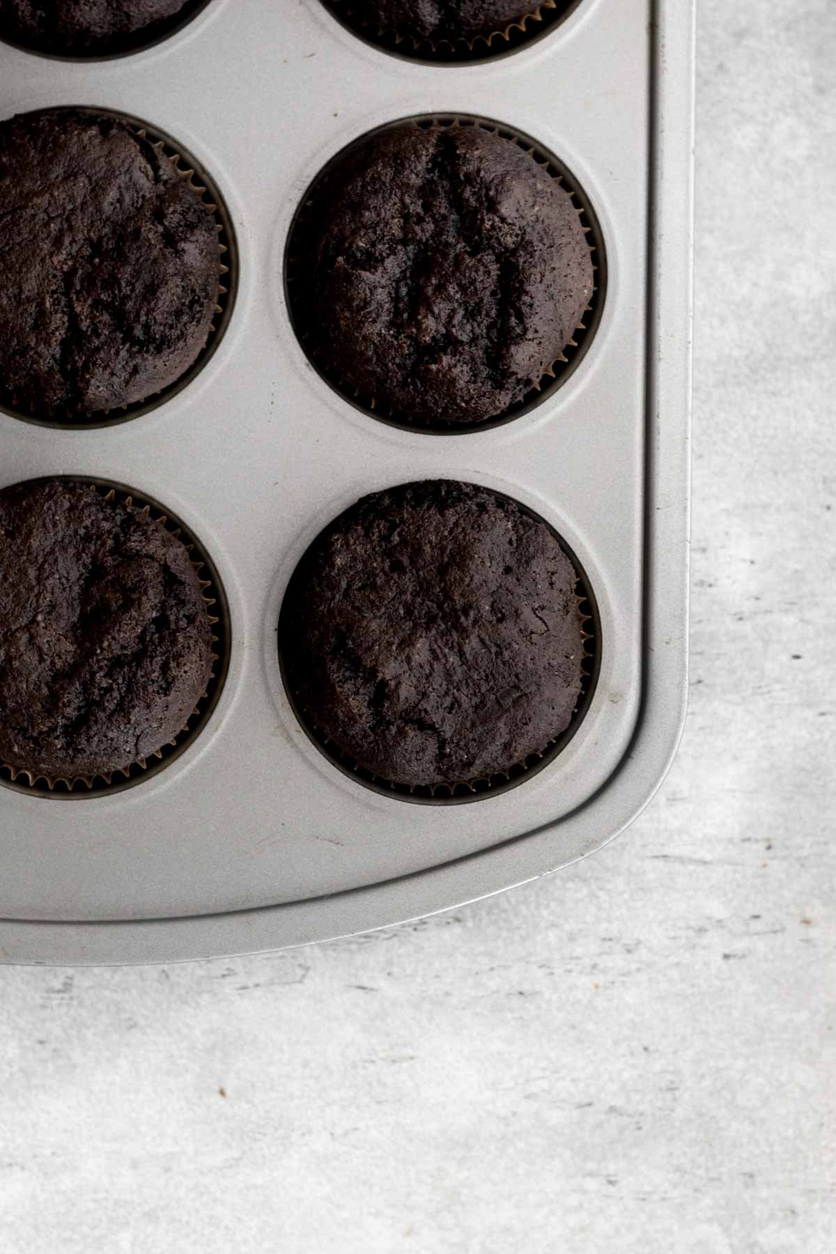 Baked chocolate cupcakes in a tin.