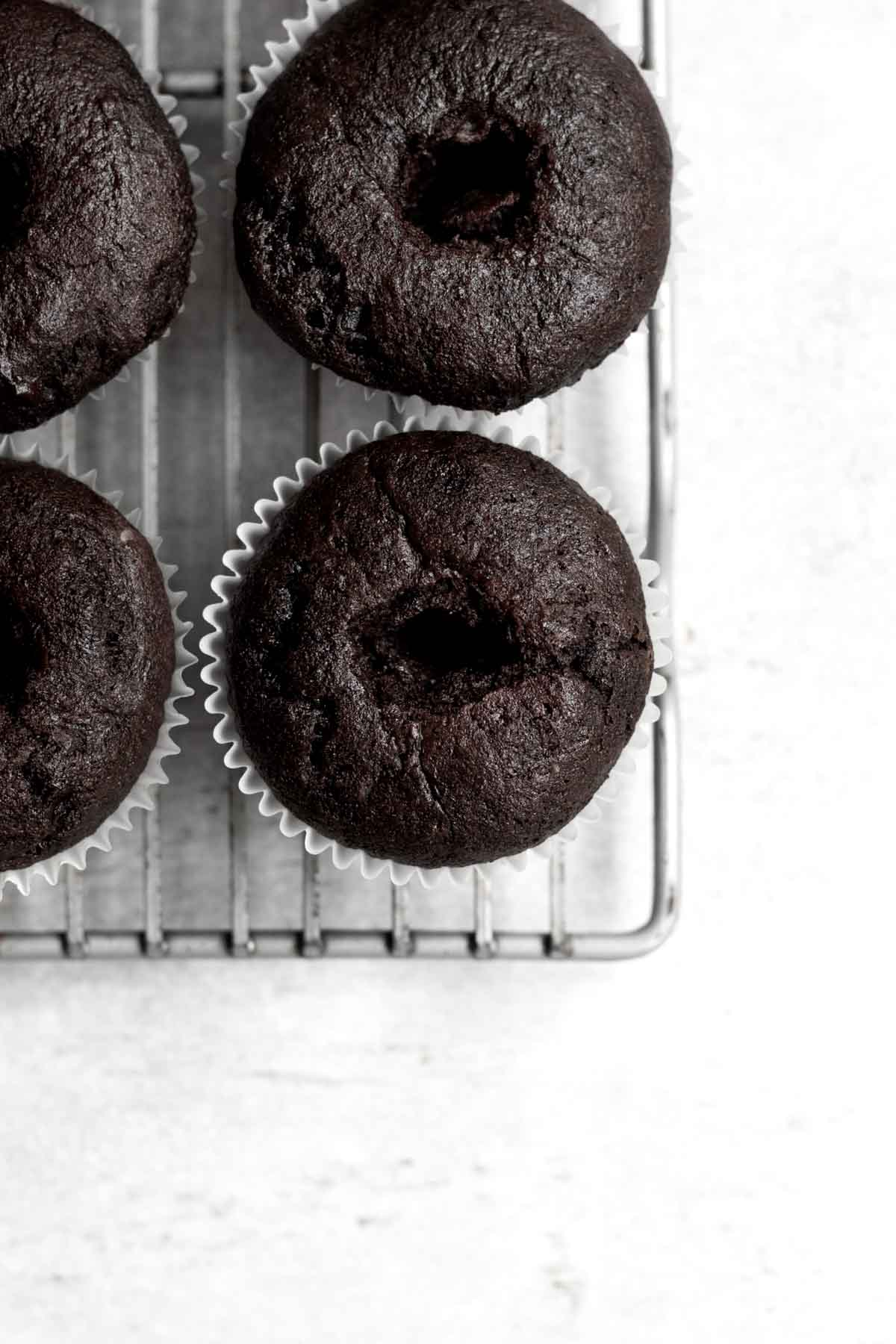 Holes are cut into the center of the cupcakes.