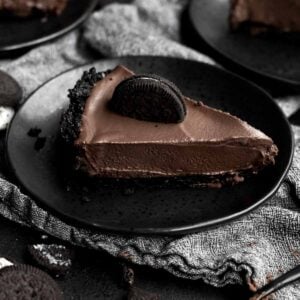 A slice of No-Bake Chocolate Pie sits proudly on a plate.