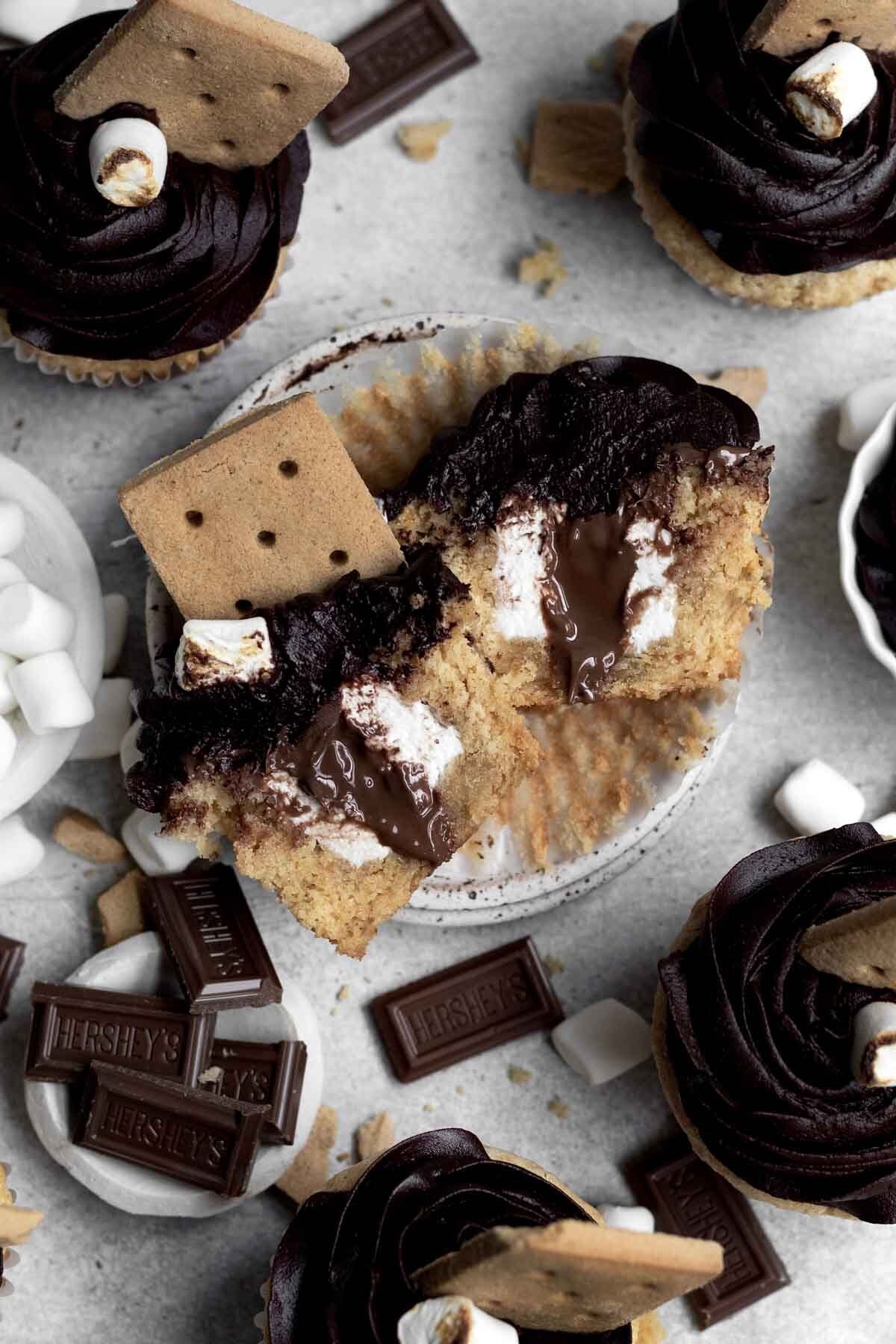 A divided S’mores cupcake oozing chocolate and warm marshmallow.