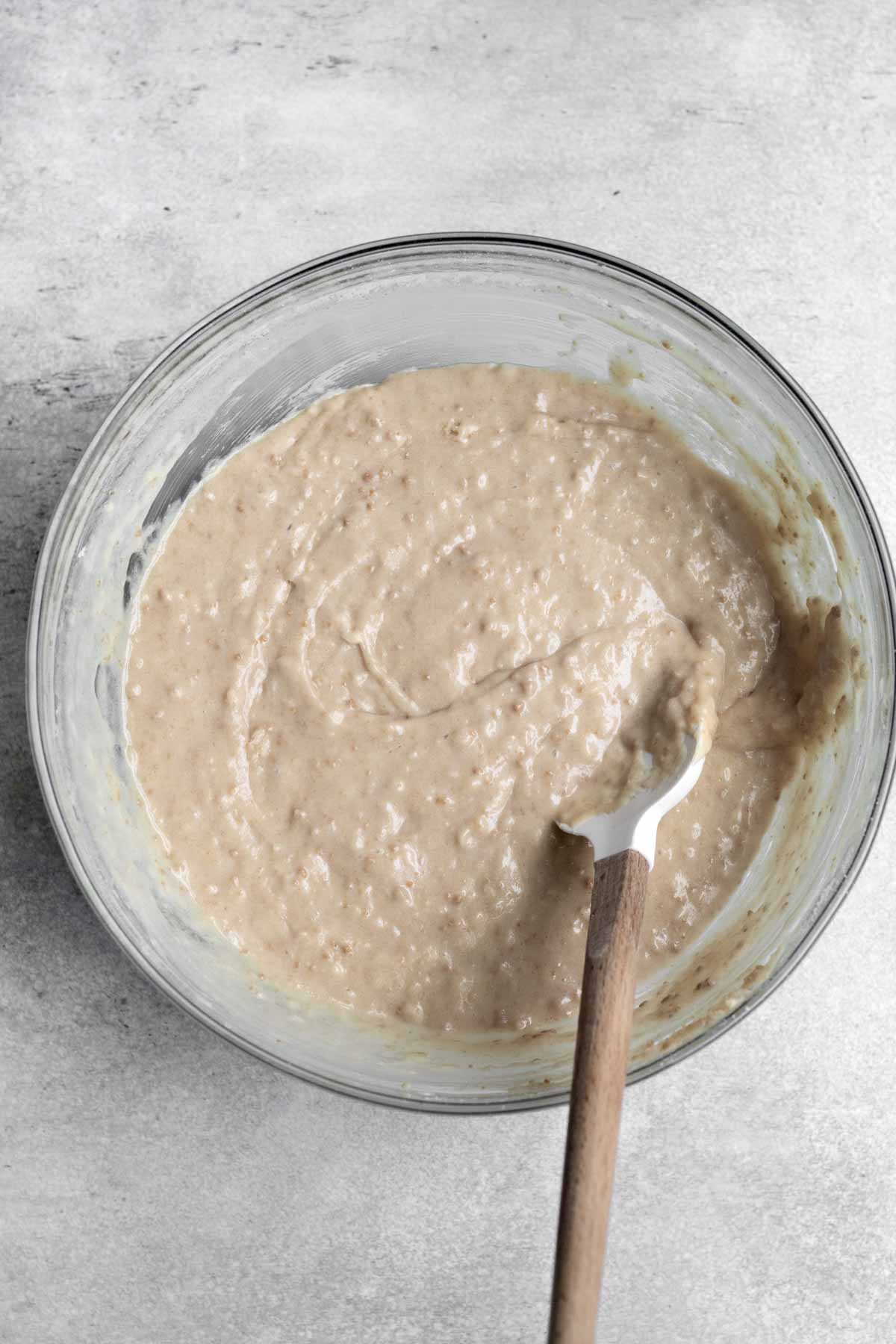 Mixing the wet and dry ingredients in a bowl.