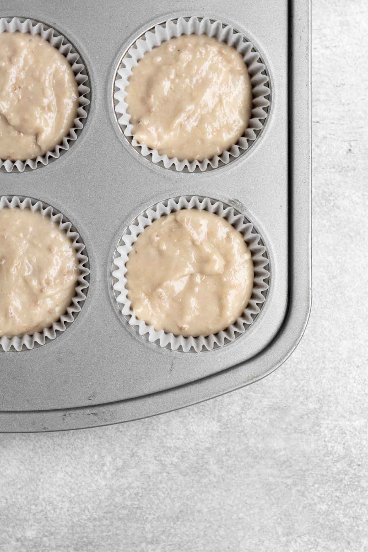 Filling a cupcake tin with the batter.