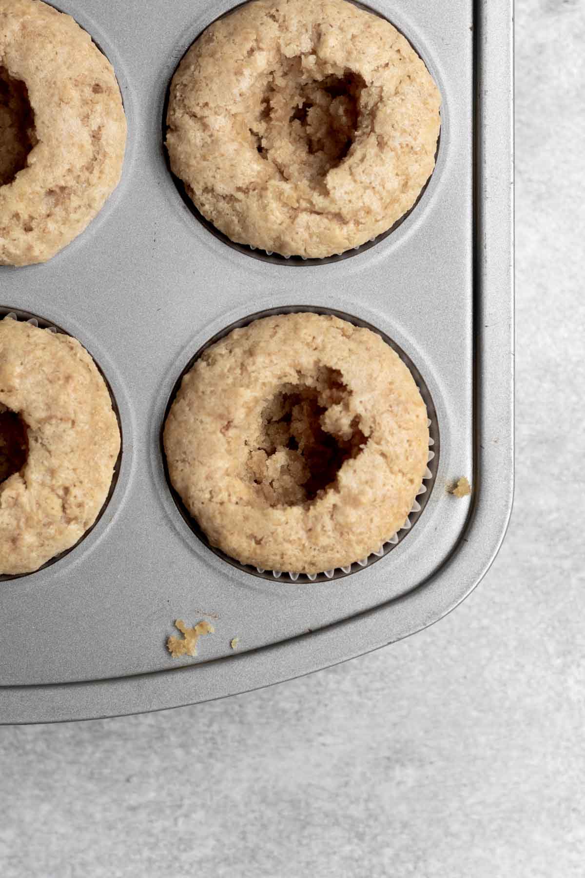 Holes are dug into the center of the cupcakes.